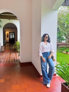 Namitha Pramod candid smile in white linen shirt garden setting