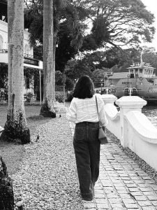 Namitha Pramod candid smile in white linen shirt garden setting