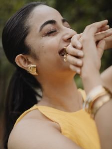 Namitha Pramod bright yellow twist dress among garden flowers