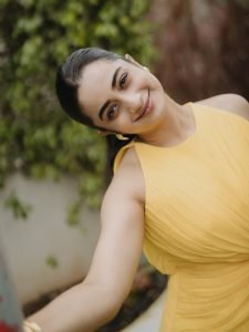 Namitha Pramod bright yellow twist dress among garden flowers