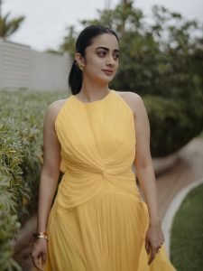 Garden greenery backdrop with Namitha Pramod vibrant yellow outfit