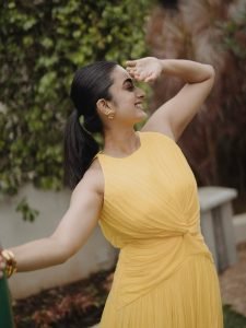 Garden greenery backdrop with Namitha Pramod vibrant yellow outfit