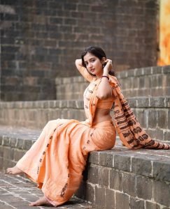 Neha Pathan printed saree detail with natural river backdrop