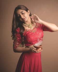Traditional oil lamps complementing Neha Pathan red lehenga shoot