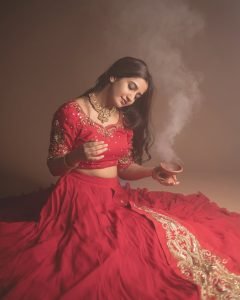 Elegant festive pose from Neha Pathan in vibrant red lehenga