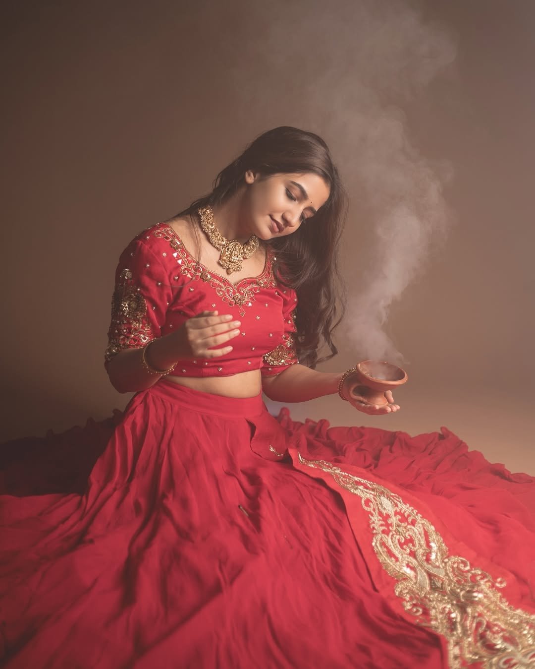 Elegant festive pose from Neha Pathan in vibrant red lehenga