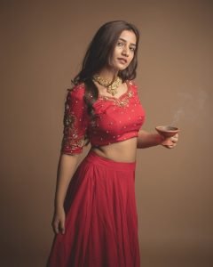 Neha Pathan red lehenga with traditional diya festive studio setup