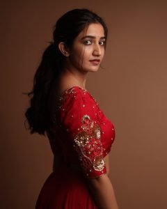 Neha Pathan red lehenga with traditional diya festive studio setup