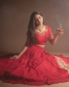 Neha Pathan celebratory expression in red lehenga Diwali theme