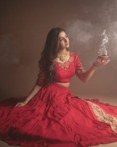 Traditional oil lamps complementing Neha Pathan red lehenga shoot