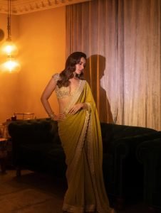Raashi Khanna glamorous pose in shimmering olive colored saree