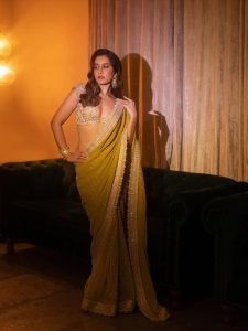 Raashi Khanna glamorous pose in shimmering olive colored saree