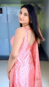 Ritika Nayak joyful expression wearing elegant pink chudidhar