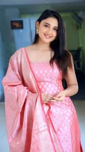 Ritika Nayak joyful expression wearing elegant pink chudidhar