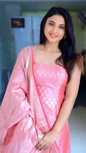 Traditional pink salwar kameez on Ritika Nayak cheerful portrait
