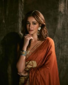 Ananya posing in heritage haveli in orange saree