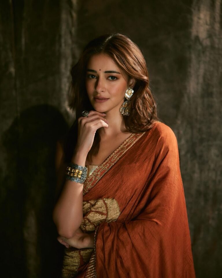 Ananya posing in heritage haveli in orange saree