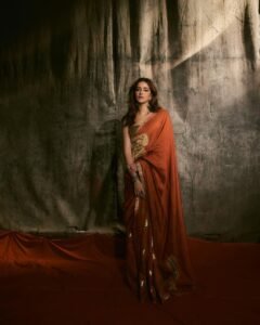 Ananya posing in heritage haveli in orange saree