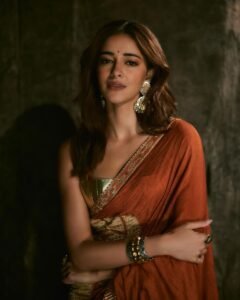 Ananya posing in heritage haveli in orange saree