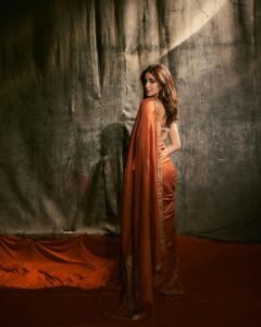 Ananya posing in heritage haveli in orange saree