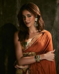 Ananya posing in heritage haveli in orange saree