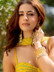 Ananya twirling in yellow saree among marigold flowers at sunset