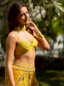 Ananya twirling in yellow saree among marigold flowers at sunset