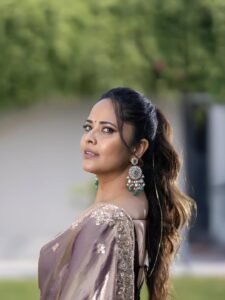 Close-up of Anasuya wearing gold vanki and red bindi in ethnic attire