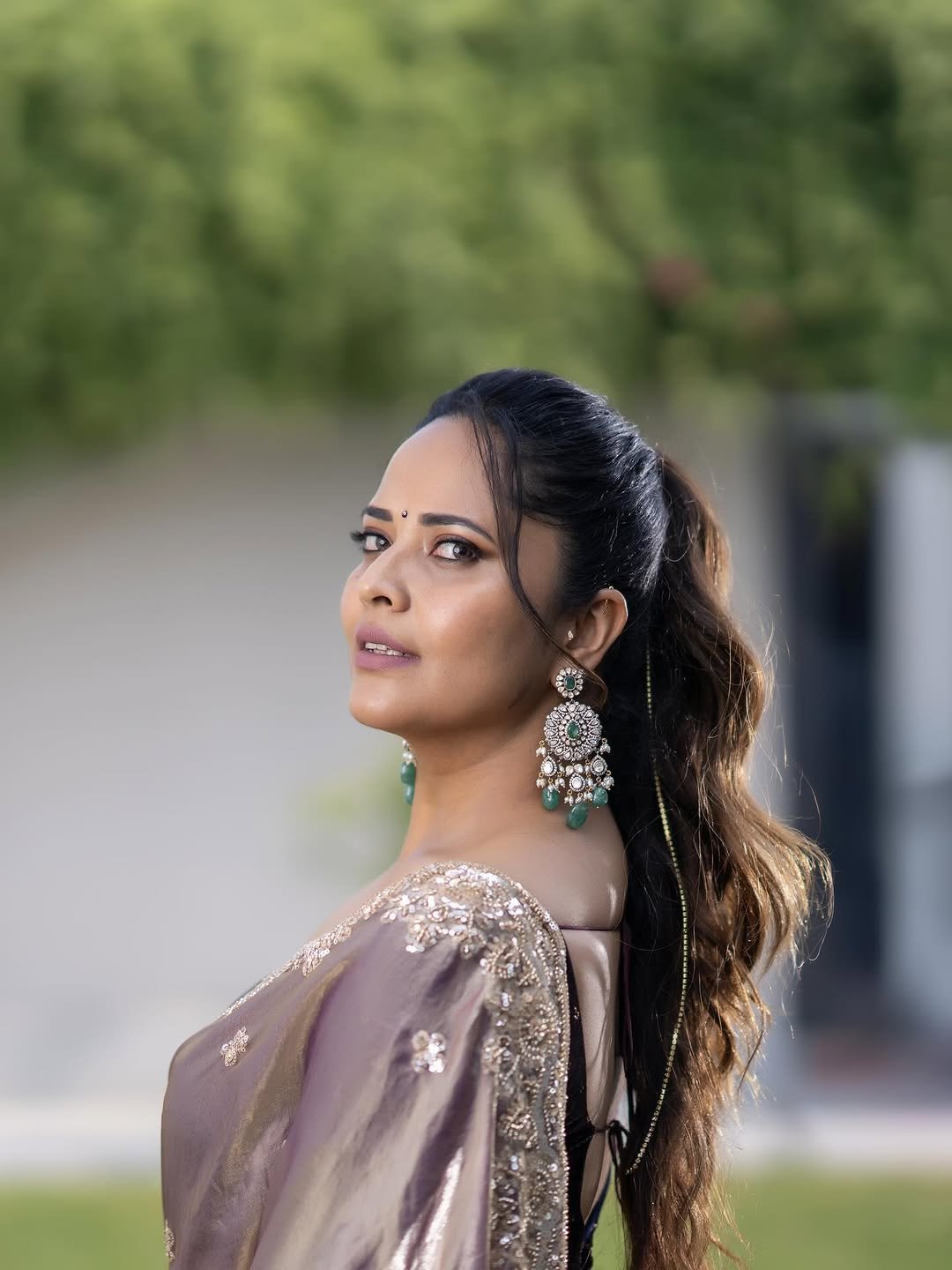 Close-up of Anasuya wearing gold vanki and red bindi in ethnic attire