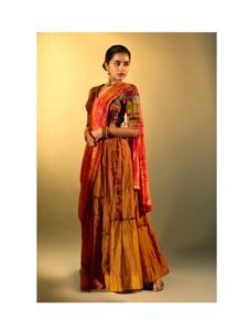 Anupama sitting on verandah in traditional South Indian attire