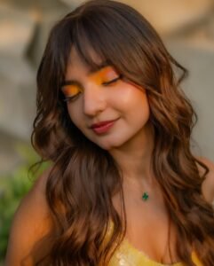 Anushka Sen with glossy lips and high ponytail in yellow outfit