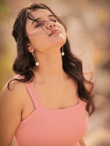 Arul twirling in pink outfit with dupatta flowing in breeze