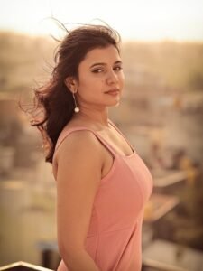 Arul twirling in pink outfit with dupatta flowing in breeze