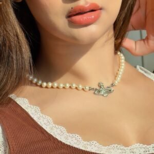 Avneet walking past graffiti wall in white tank and sneakers