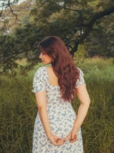 Ayesha walking barefoot on forest path with woven basket