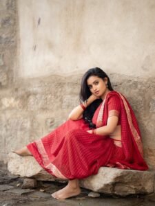 Deepika Pilli in crimson Gadwal saree with gold zari during traditional shoot