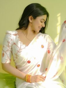 Delna Davis in white Kasavu saree with gold border during traditional shoot