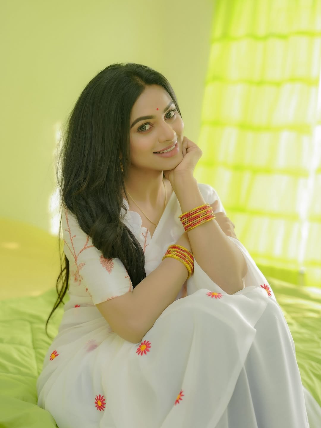 Delna Davis in white Kasavu saree with gold border during traditional shoot