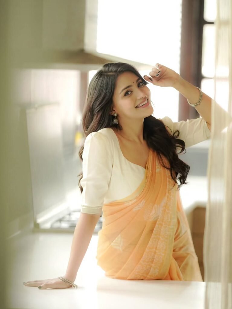 Dharshna Sripal Golecha in peach georgette saree with white blouse