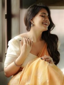 Dharshna Sripal Golecha in peach georgette saree with white blouse