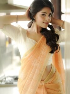 Close-up of Dharshna wearing pearl earrings and low bun in ethnic attire