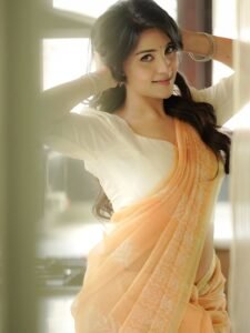 Close-up of Dharshna wearing pearl earrings and low bun in ethnic attire