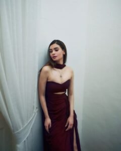 Close-up of Diana with plum lips and sleek low bun in evening attire