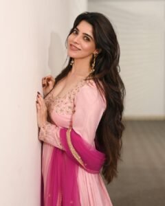 Full-length shot of Divya twirling in flowing pink Anarkali suit