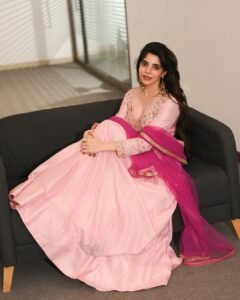 Full-length shot of Divya twirling in flowing pink Anarkali suit