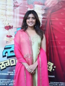 Close-up of Eesha wearing gold jhumkas and pink bangles