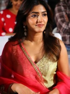 Close-up of Eesha wearing gold jhumkas and pink bangles