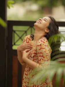 Komalee walking casually in white sneakers and neutral outfit