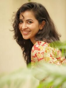 Komalee walking casually in white sneakers and neutral outfit