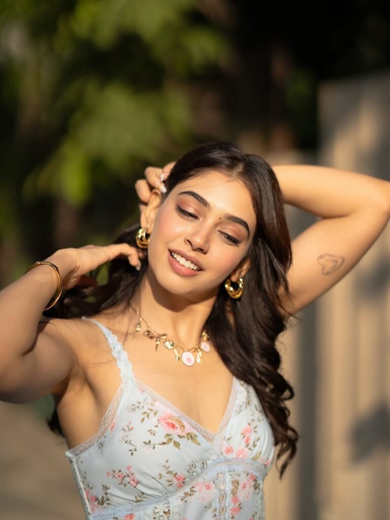 Niti sitting on park bench in floral summer dress